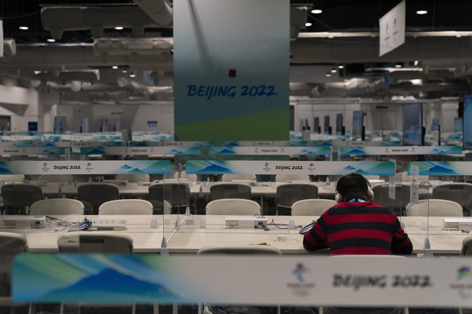 A journalist works in a media workroom at the main media center at the 2022 Winter Olympics, Tuesday, Jan. 25, 2022, in Beijing. (AP Photo/Jae C. Hong)