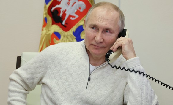 Russian President Vladimir Putin speaks on the phone with seven-year-old David Shmelev from the Stavropol Krai region, a participant in the Fir Tree of Wishes charity campaign via video conference from the N…