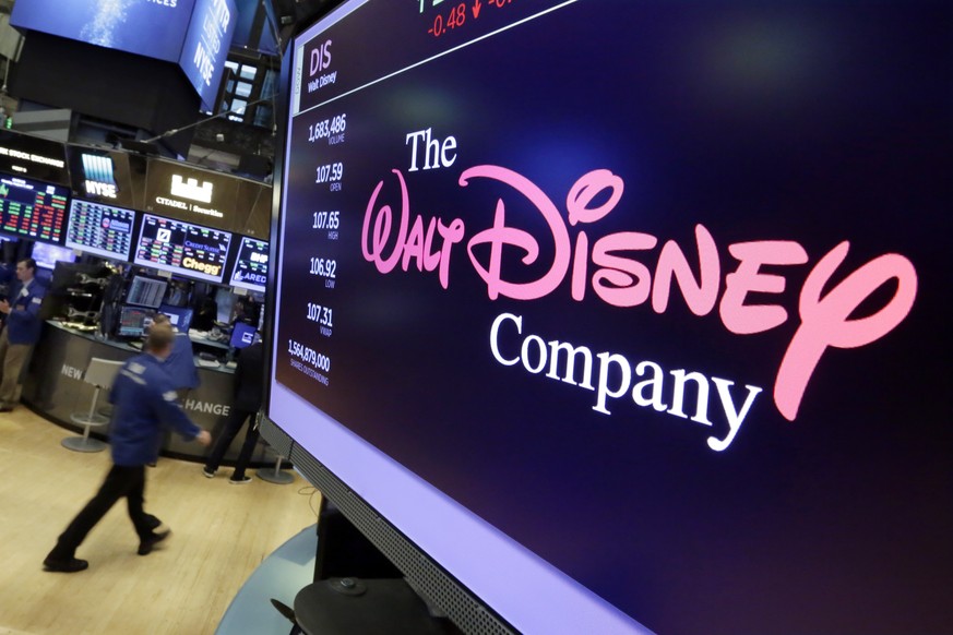 FILE - In this Aug. 8, 2017, file photo, The Walt Disney Co. logo appears on a screen above the floor of the New York Stock Exchange. Disney is buying a large part of the Murdoch family&#039;s 21st Ce ...
