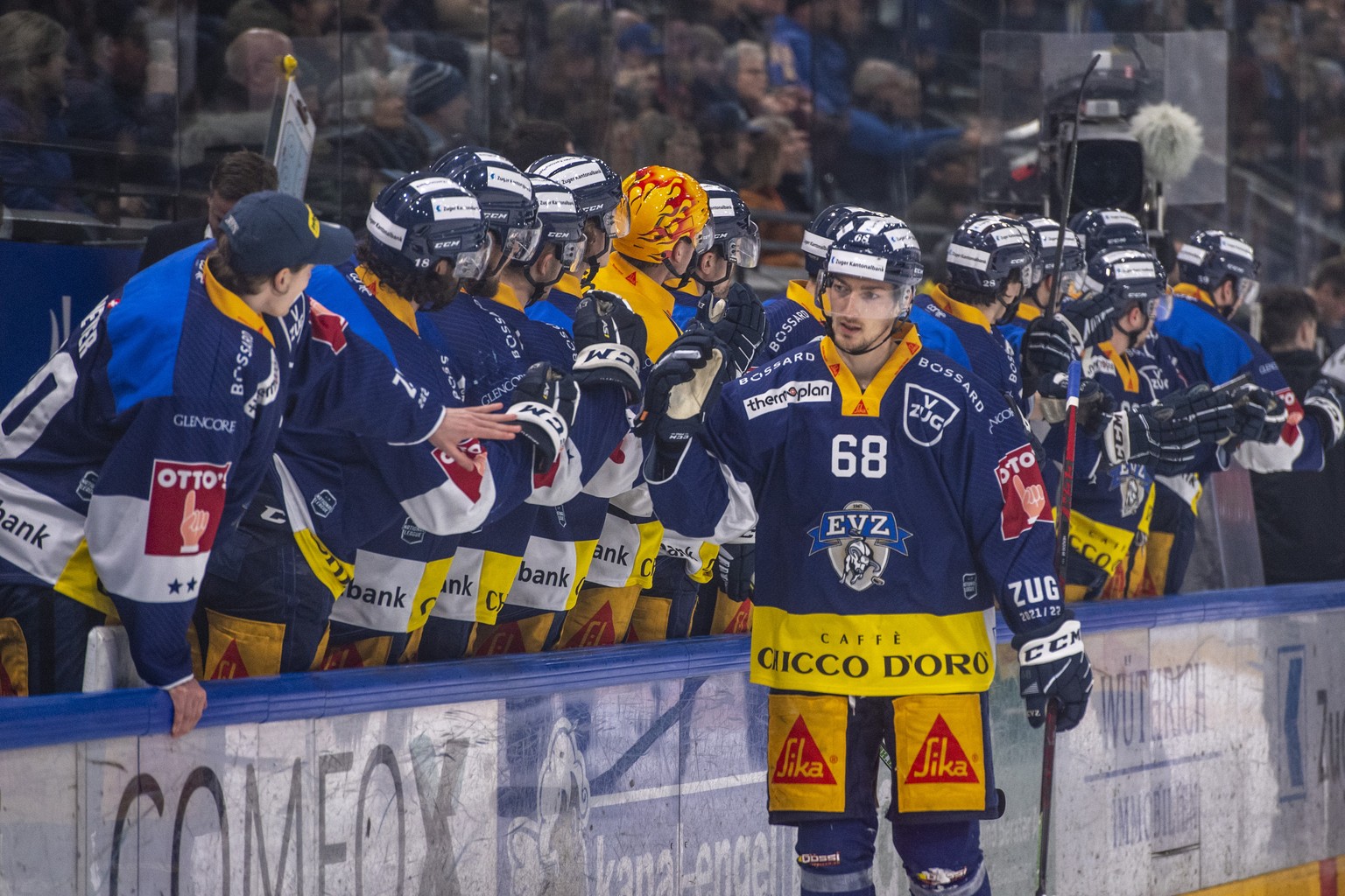 Fabrice Herzog, mitte, von Zug feiert ein Tor beim Eishockey Qualifikationsspiel der National League zwischen dem EV Zug und dem HC Fribourg Gotteron am Mittwoch, 2. Maerz 2022 in Zug. (KEYSTONE/Urs F ...