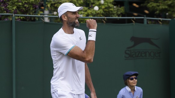 Croatia&#039;s Ivo Karlovic celebrates after winning the second set against Italy&#039;s Thomas Fabbiano in a Men&#039;s singles match during day three of the Wimbledon Tennis Championships in London, ...