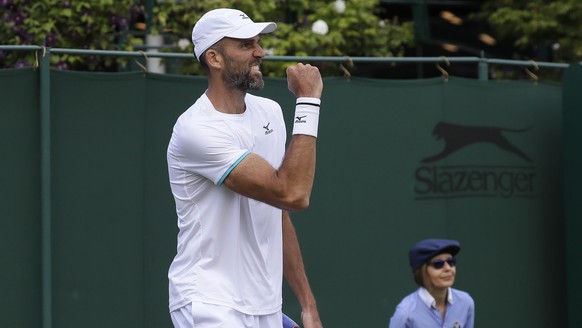 Croatia's Ivo Karlovic celebrates after winning the second set against Italy's Thomas Fabbiano in a Men's singles match during day three of the Wimbledon Tennis Championships in London, ...