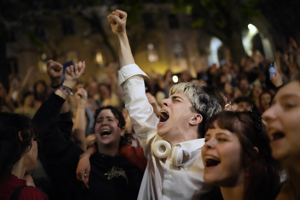 Thousands of people sing the folk song Grandola, Vila Morena, in the first minutes of Thursday, April 25, 2024, at the Carmo square in Lisbon, as the country celebrates the fiftieth anniversary of the ...