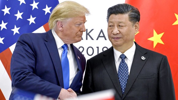 FILE - President Donald Trump, left, shakes hands with China&#039;s President Xi Jinping during a meeting on the sidelines of the G-20 summit in Osaka, Japan, June 29, 2019. (AP Photo/Susan Walsh, Fil ...