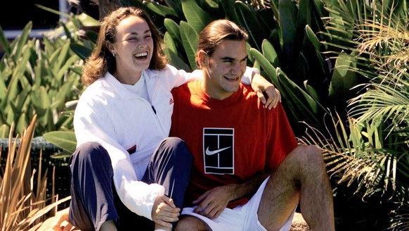 Swiss Hopman Cup teamates Roger Federer and Martina Hingis enjoy the warm sunshine on a bridge during a media call at Burswood Resort in Perth, Australia Saturday, December 30, 2000. The Hopman Cup fe ...