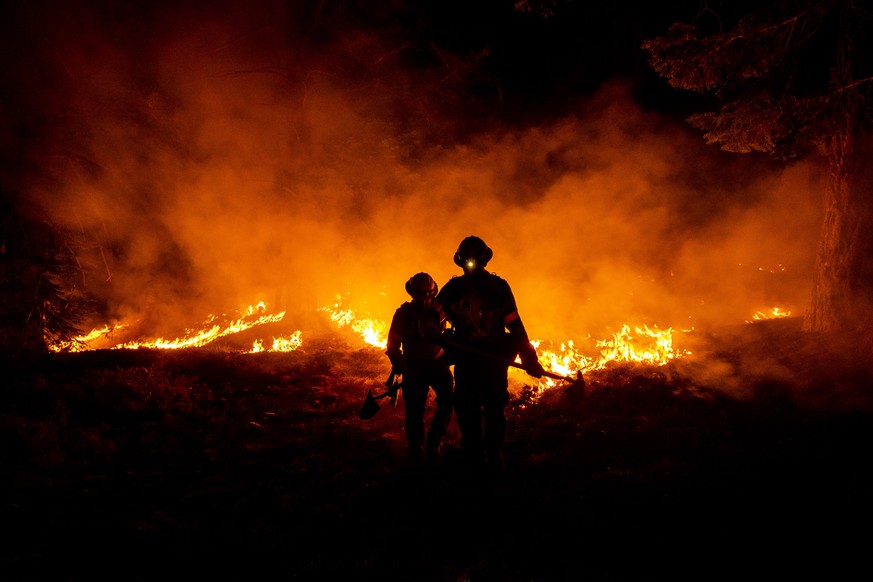 epa08663119 Firefighters work at containing the progress of the bobcat fire progress in the Angeles National Forest north of Monrovia, north East of Los Angeles, California, USA, 11 September 2020 (is ...