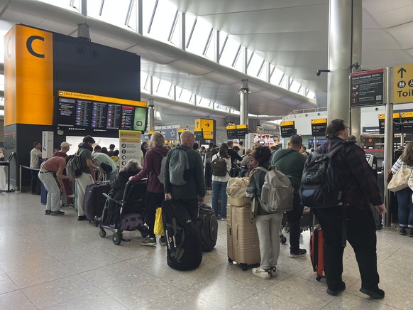 People queuing at T2 London Heathrow Airport, after flights were delayed and cancelled at airports including Heathrow after an alleged cyber attack targeted a service provider for check-in and boardin ...