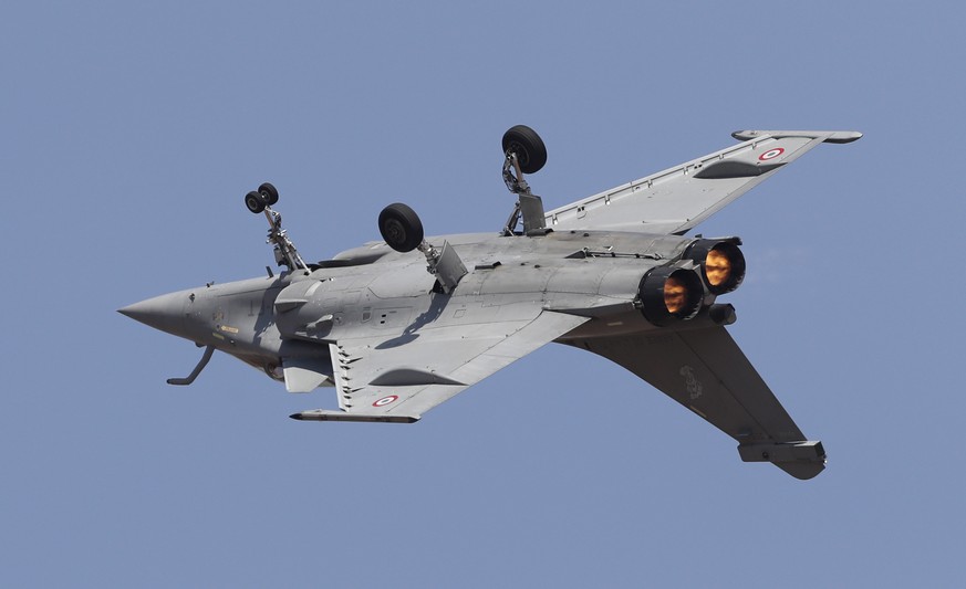 Rafale, a French fighter aircraft, flies inverted performing aerobatic maneuvers on the inaugural day of Aero India 2019 at Yelahanka air base in Bangalore, India, Wednesday, Feb. 20, 2019. Aero India ...