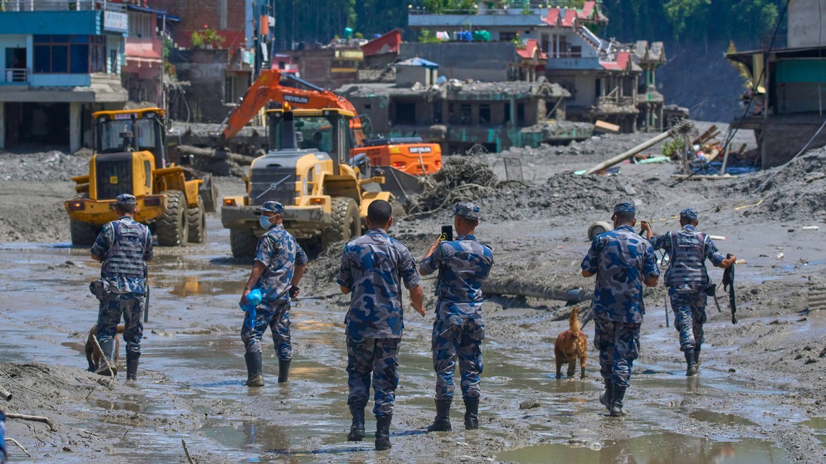 Nepalese policemen watch as earthmovers clear the debris of flash flooding in Nepal's Nuwakot district, Thursday, Aug. 27, 2026. (AP Photo/Niranjan Shrestha)
Nepal Flash Floods