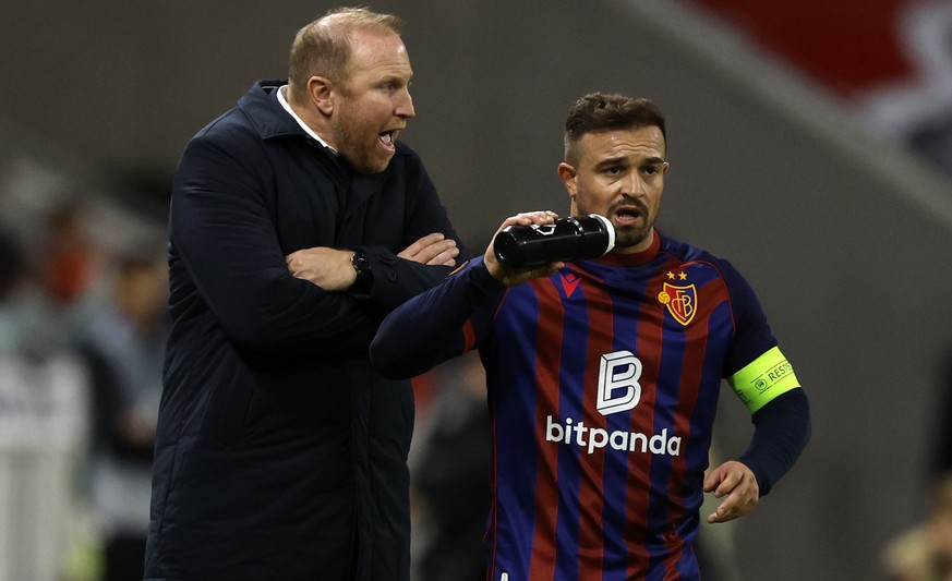 epa12476474 Ludovic Magnin (L) head coach of FC Basel speaks with Xherdan Shaqiri (R) of FC Basel during the UEFA Champions League phase match between Olympique Lyon and FC Basel 1893, in Decines-Chap ...