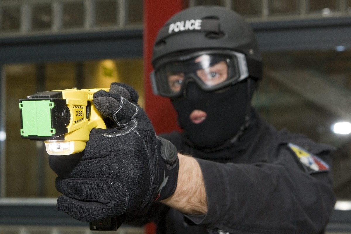 A member of Geneva's Intervention Group Police demonstrates a Taser X26 electroshock weapon at the Geneva Police headquarters in Geneva, Switzerland, Monday, April 27, 2009. A Taser is an electro ...