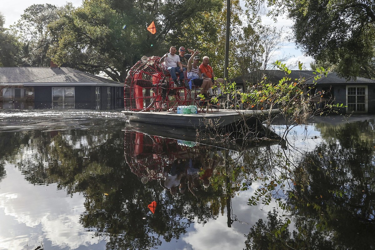 Residents use an airboat to reach dry land in a neighborhood still flooded from Hurricane Milton as the area prepares to have the FEMA Disaster Recover Center covert to a polling location for the gene ...