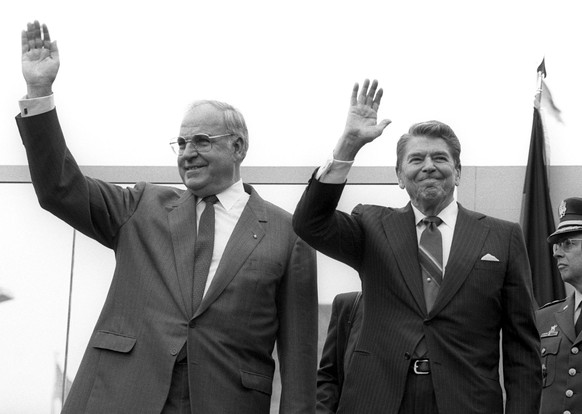 epa06031698 (FILE) - A file picture dated 12 June 1987 shows US president Ronald Reagan (R) and German former chancellor Helmut Kohl (L) waving as Reagan visits the Berlin Wall in West Berlin, Germany ...