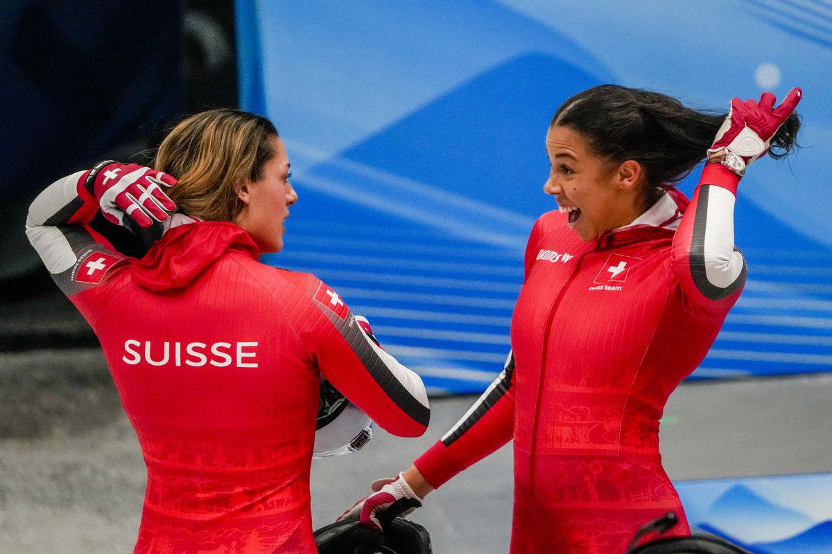 Melanie Hasler and Nadja Pasternack, of Switzerland, celebrate after the women's bobsleigh heat 4 at the 2022 Winter Olympics, Saturday, Feb. 19, 2022, in the Yanqing district of Beijing. (AP Pho ...