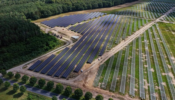 epa11527519 A picture taken with a drone shows a construction site of an open-space photovoltaic system (solar park) close to Petershagen in the east of Berlin, Germany, 05 August 2024. According to t ...