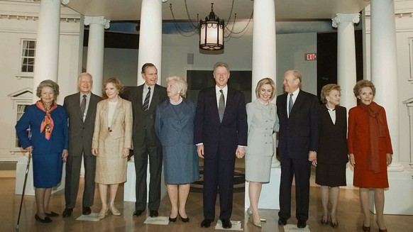 Current and former occupants of the White House pose for a photo in front of a replica of the presidential residence at the George Bush Presidential Library in College Station, Texas, Thursday, Nov. 6 ...