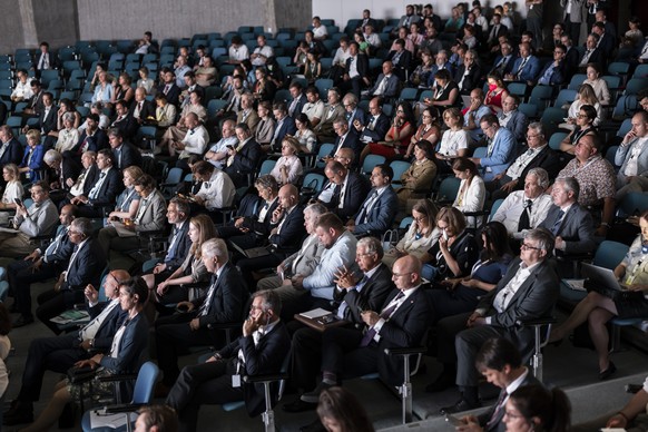 Participants listen to speeches during the Economic Forum official opening following the Ukraine Recovery Conference URC, Tuesday, July 5, 2022 in Lugano, Switzerland. The URC is organised to initiate ...