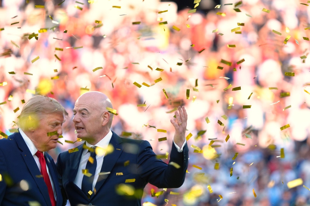 President Donald Trump, left, speaks with FIFA President Gianni Infantino as confetti falls at the conclusion of the World Cup championship final soccer match between Spain and Argentina in East Ruthe ...