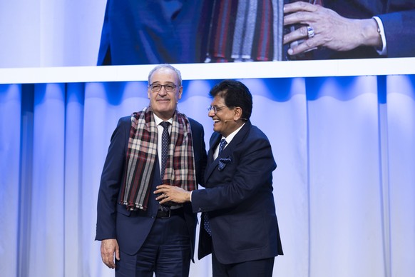 India?s Minister of Commerce and Industry, Piyush Goyal, right, hands over a cashmere scarf as a present to Swiss Federal Councillor and head of Federal Department of Economic Affairs, Education and R ...