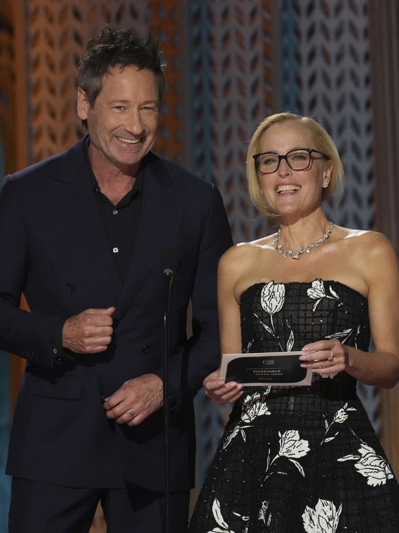 David Duchovny, left, and Gillian Anderson present the award for outstanding performance by an ensemble in a drama series during the 31st annual Screen Actors Guild Awards on Sunday, Feb. 23, 2025, at ...