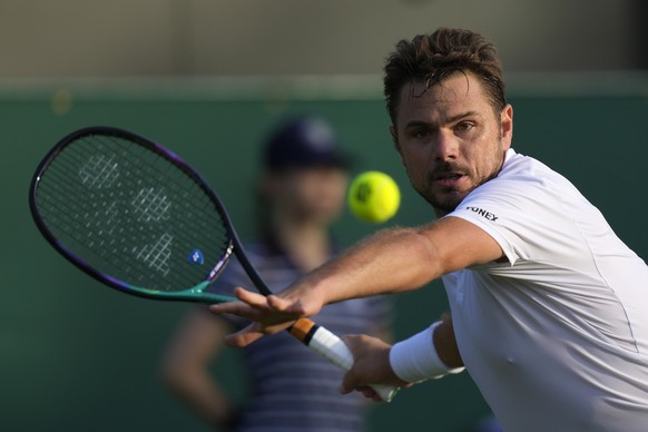 Switzerland&#039;s Stan Wawrinka returns the ball to Italy&#039;s Jannik Sinner during their men&#039;s singles match on day one of the Wimbledon tennis championships in London, Monday, June 27, 2022. ...