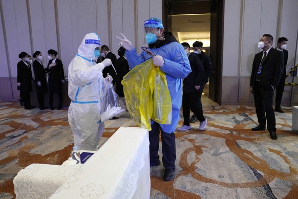 Health workers collect swab samples from the environment before a session for the Financial Street Forum 2022 held in Beijing, Monday, Nov. 21, 2022. China is the only major country in the world still ...