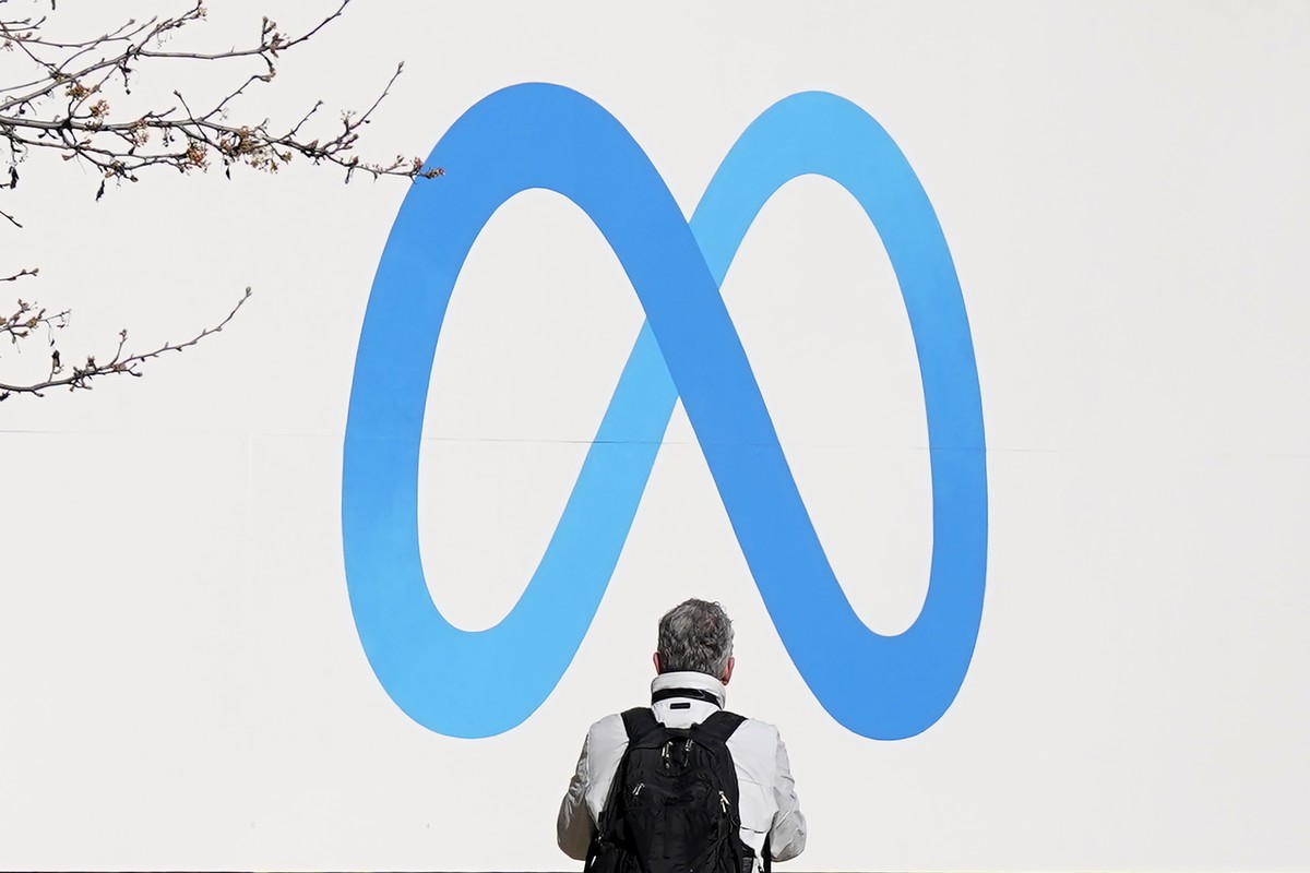 FILE - A person stands in front of a Meta sign outside of the company's headquarters in Menlo Park, Calif., March 7, 2023. Meta releases results on Thursday, Feb. 1, 2024. (AP Photo/Jeff Chiu, Fi ...