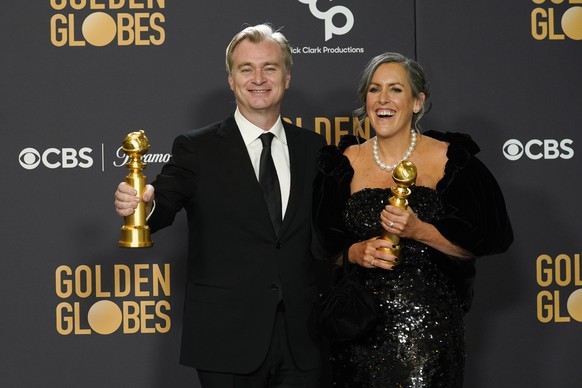Christopher Nolan, left, and Emma Thomas pose in the press room with the award for best film, drama "Oppenheimer" at the 81st Golden Globe Awards on Sunday, January 7, 2024, in the…