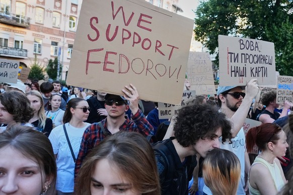 Activists shout slogans during a rally to denounce President Volodymyr Zelenskyy's decision to dismiss Defense Minister Mykhailo Fedorov after six months in the post, Friday, July 17, 2026, Kyiv, ...