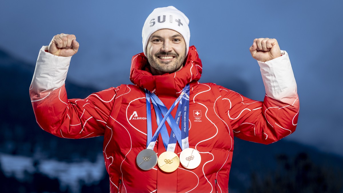 Gold medalist Switzerland's Loic Meillard poses with his medals for a portrait after the men's alpine skiing slalom race at the 2026 Olympic Winter Games at the Stelvio Ski centre in Bormio, ...