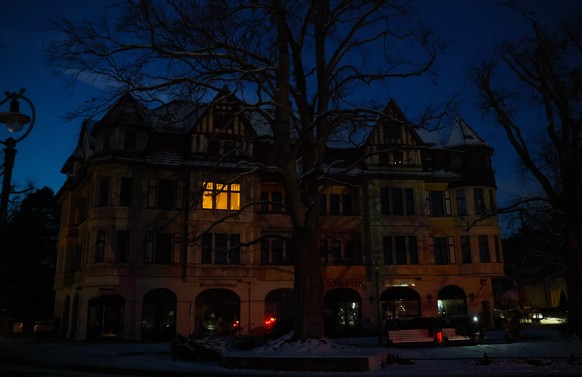 epa12629030 A single window of a house is lit up during a power outage in southwest Berlin, Germany, 05 January 2026. According to state-owned operator Stromnetz Berlin, a large-scale power outage in  ...