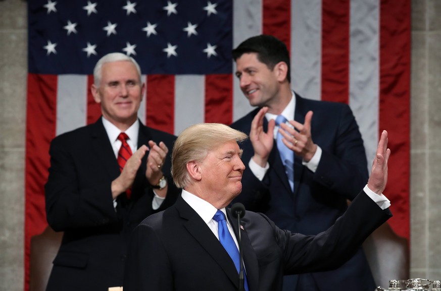 epa06486916 US President Donald J. Trump waves during the State of the Union address as US Vice President Mike Pence (L) and Speaker of the US House of Representatives Paul Ryan (R) look on in the cha ...