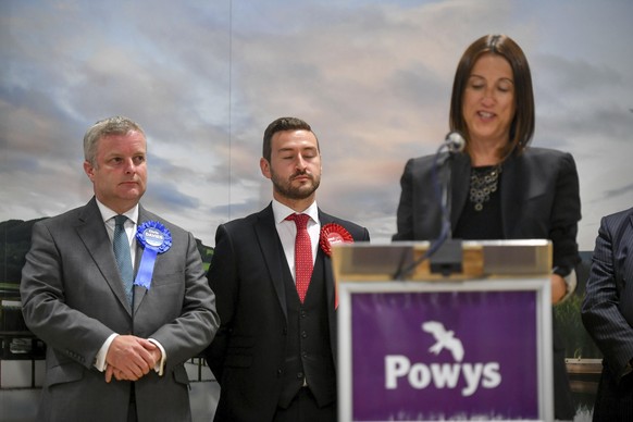 Conservative candidate Chris Davies, left, looks as Liberal Democrats&#039; Jane Dodds, right, gives a winner&#039;s speech after winning the seat in the Brecon and Radnorshire by-election at the Roya ...