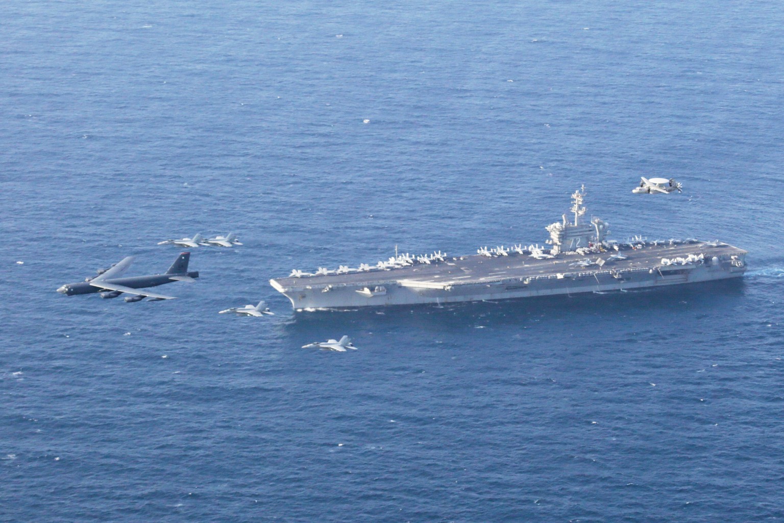 FILE - The USS Abraham Lincoln carrier and a U.S. Air Force B-52H Stratofortress, conduct joint exercises in the U.S. Central Command area of responsibility in Arabian Sea June 1, 2019. (Mass Communic ...