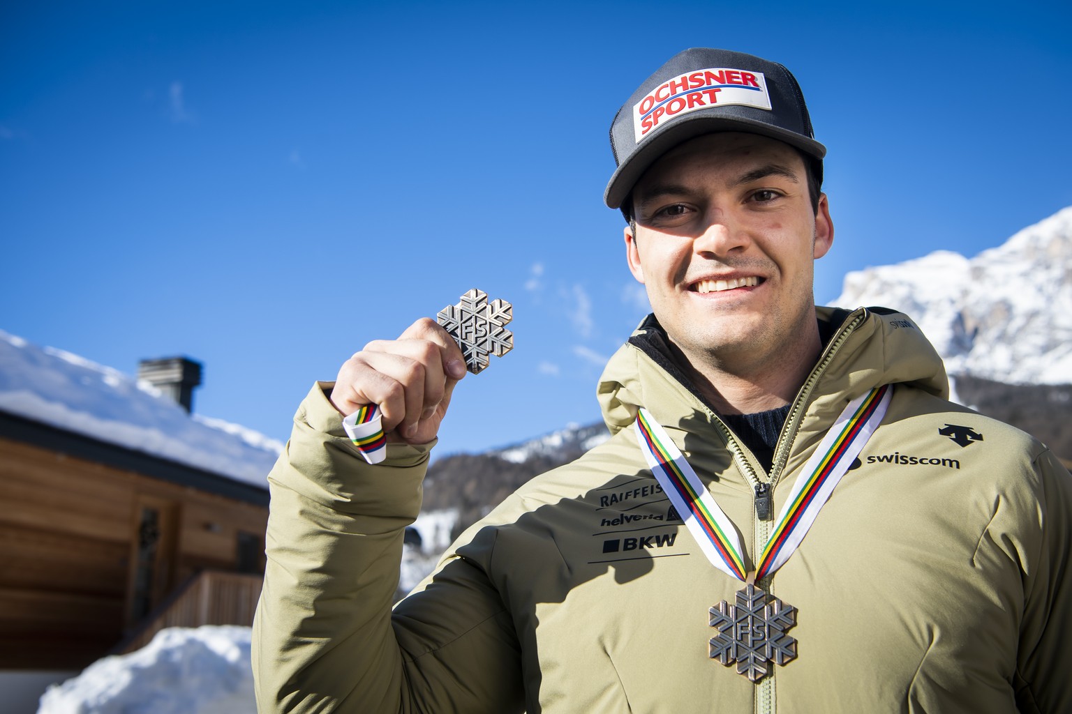 Loic Meillard of Switzerland poses with the Bronze medal for Parallel race and the Bronze medal for Alpine Combined race at the 2021 FIS Alpine Skiing World Championships in Cortina d&#039;Ampezzo, It ...