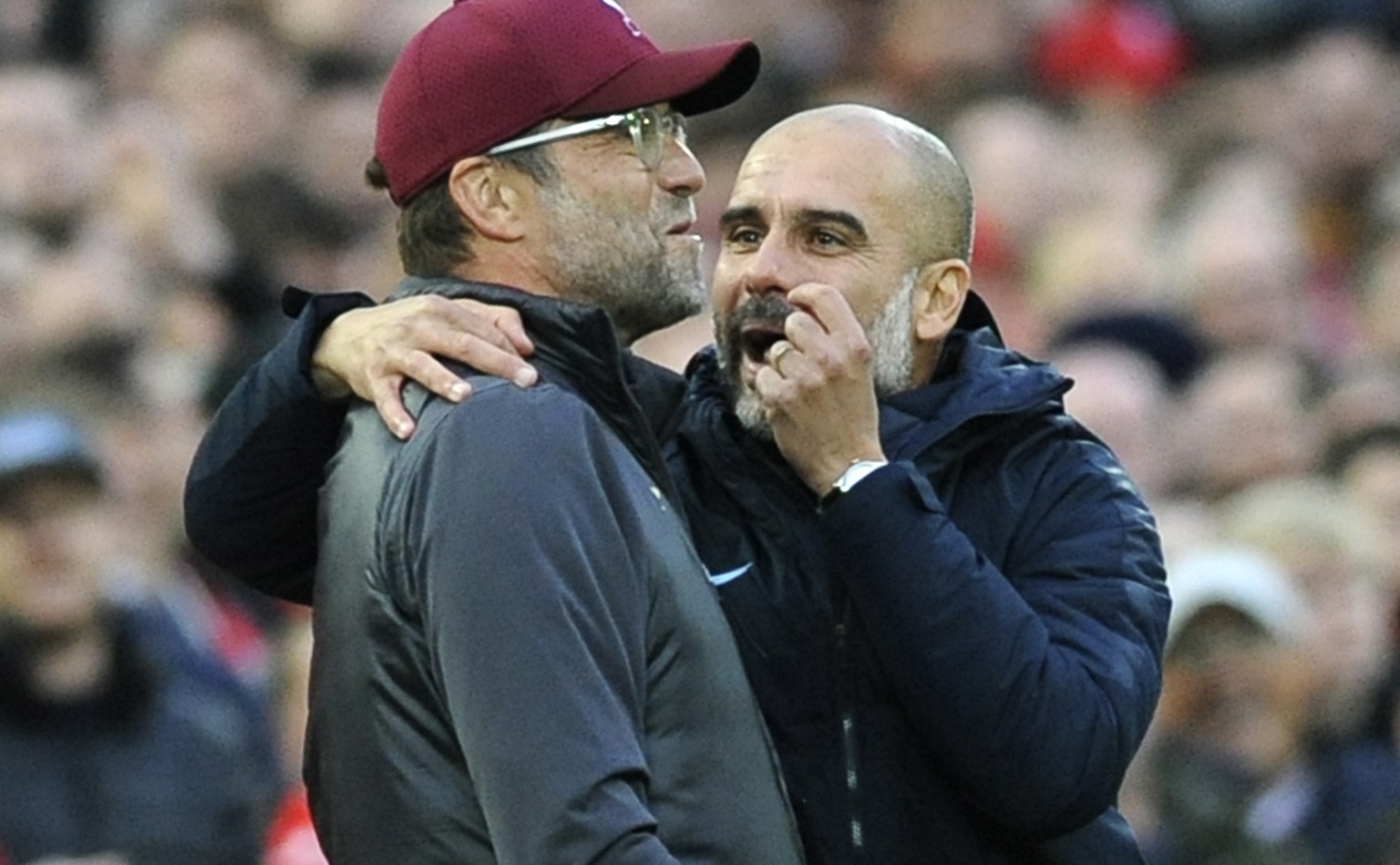 Manchester City manager Josep Guardiola, right, and Liverpool manager Juergen Klopp talk during the English Premier League soccer match between Liverpool and Manchester City at Anfield stadium in Live ...