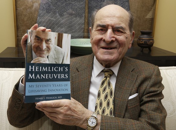 FILE - In this Feb. 5, 2014, file photo, Dr. Henry Heimlich holds his memoir prior to being interviewed at his home in Cincinnati. Heimlich, the surgeon who created the life-saving Heimlich maneuver f ...