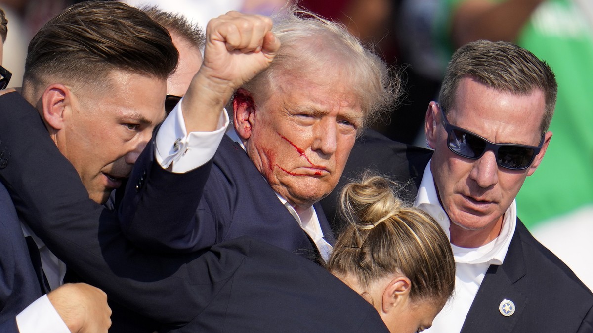 Republican presidential candidate former President Donald Trump is helped off the stage by U.S. Secret Service agents at a campaign event in Butler, Pa., on Saturday, July 13, 2024. (AP Photo/Gene J.  ...