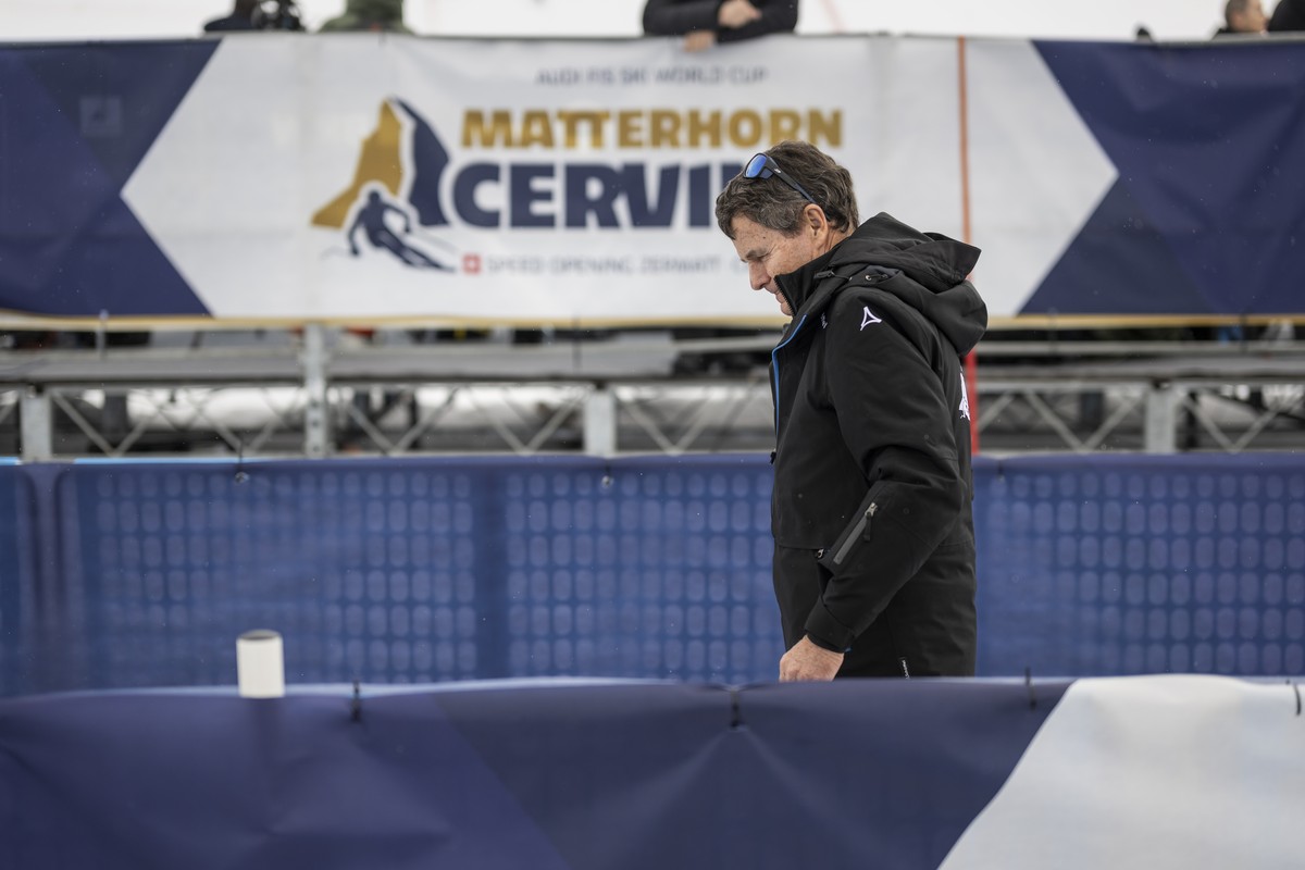 Franz Julen, president of the organizing committee, leaves the finish area after the women's downhill race on the new ski course "Gran Becca" was cancelled due to strong winds, at the A ...