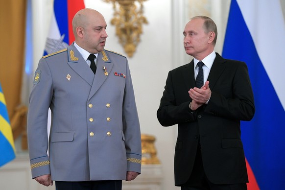 FILE - Russian President Vladimir Putin, right, applauds Col. Gen. Sergei Surovikin during an awards ceremony for troops who fought in Syria, in the Kremlin, in Moscow, Russia, Dec. 28, 2017. Suroviki ...