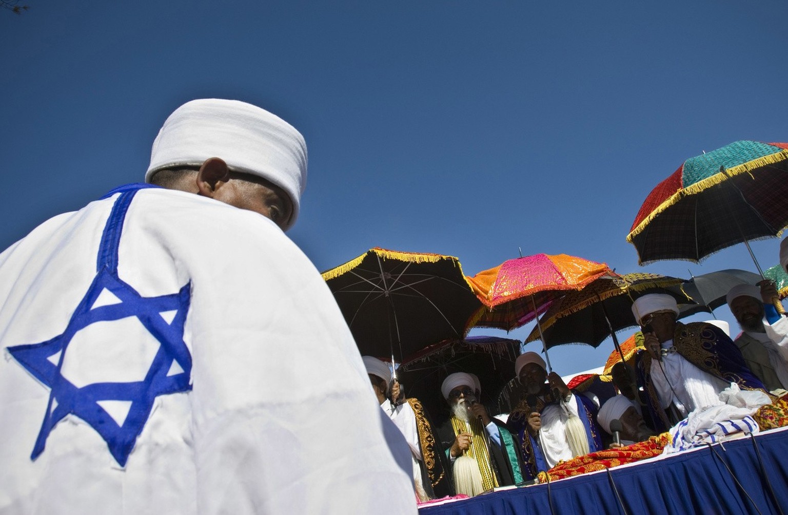 Ethiopian Jewish clergymen use umbrellas to protect themselves from the sun as they pray during the &#039;Sigd&#039; holy day on a hill overlooking Jerusalem, Thursday, Nov. 27, 2008. The prayer is pe ...