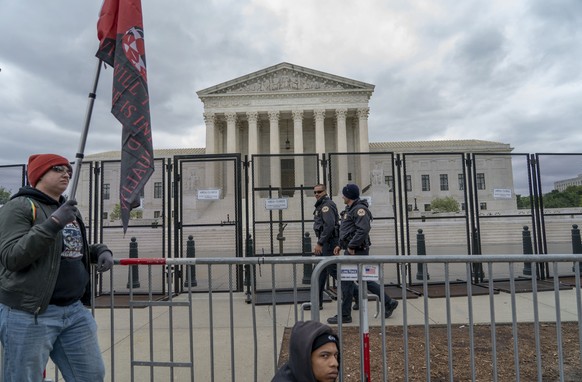 Abortion-rights protesters display flags during a demonstration outside of the U.S. Supreme Court, Sunday, May 8, 2022, in Washington. A draft opinion suggests the Supreme Court could be poised to ove ...