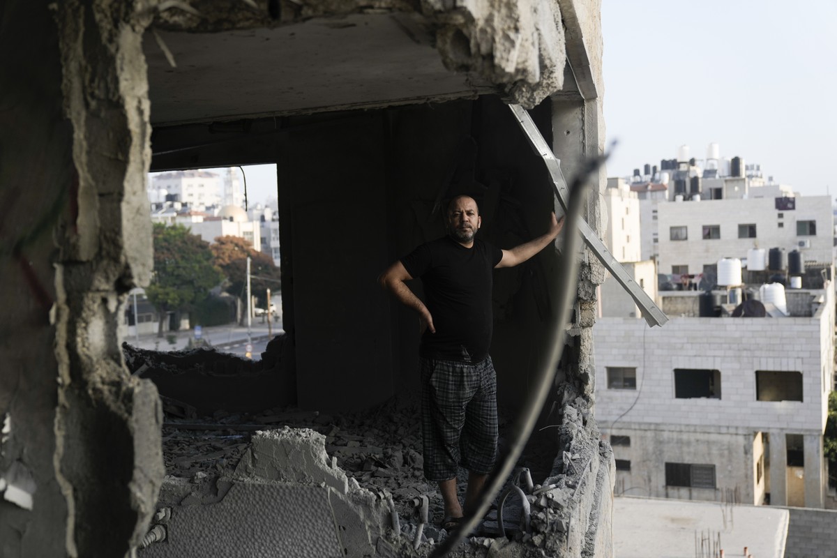 A Palestinian looks at the apartment of Khaled Kharousha that was destroyed by the Israeli military in Nablus, West Bank, Friday, Nov. 3, 2023. Israel's High Court of Justice gave the army the go ...