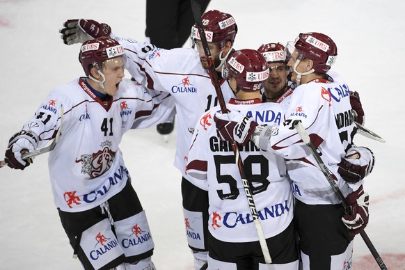 Dinamo Riga with Riga&#039;s Miks Indrasis, right, celebrate after Indrasis scored 3-4, during the game between Haemeenlinna PK and Dinamo Riga, at the 91th Spengler Cup ice hockey tournament in Davos ...