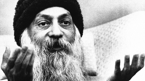 The Bhagwan Shree Rajneesh tells a news conference on Monday, Sept. 17, 1985 in Rajneeshpuram, Oregon, that his former personal secretary and spokeswoman, Ma Anand Sheela and six other former commune leaders mismanaged operations and left the city $55 million in debt. The seven have left the Oregon commune. (AP Photo/Jack Smith)
