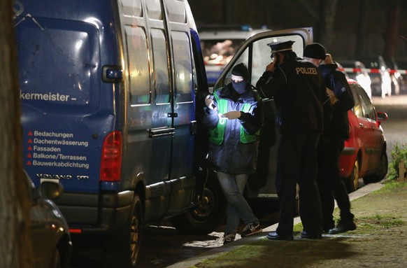 BERLIN, GERMANY - NOVEMBER 26: Police inspect an item they found while searching a van after they arrested two men at the van in Britz district earlier in the day on November 26, 2015 in Berlin, Germa ...