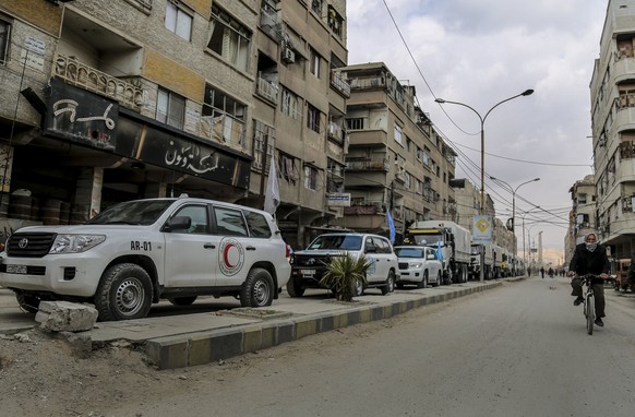 epa06525715 A handout photo made available by Syrian Arab Red Crescent (SARC) shows Humanitarian aid convoy reaching Eastern Ghouta in rural Damascus , Syria 14 February 2018. According to Syrian Arab ...