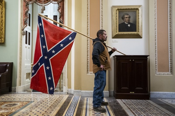 epa08937766 (FILE) - Supporters of US President Donald J. Trump and his baseless claims of voter fraud breach stand outside the Senate chamber during their protest against Congress certifying Joe Bide ...