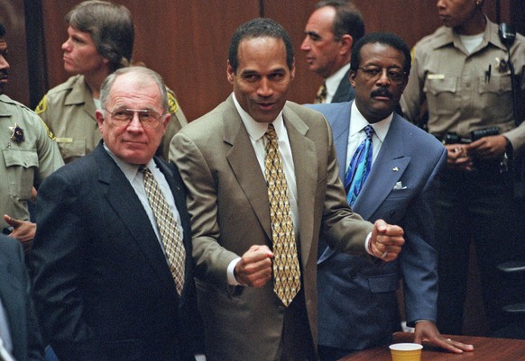 FILE - In this Oct. 3, 1995 file photo, O.J. Simpson, center, reacts as he is found not guilty of murdering his ex-wife Nicole Brown and her friend Ron Goldman, as members of his defense team, F. Lee  ...