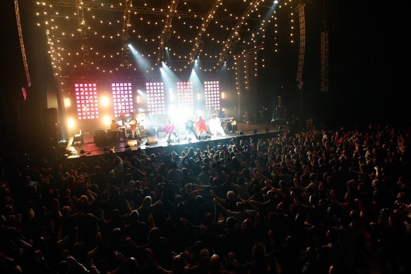 Spectactors cheer during the final with the zouk band Kassav&#039; and others singer during a concert in solidarity for the victims of the earthquake in Haiti at the Arena in Geneva, Switzerland, Wedn ...